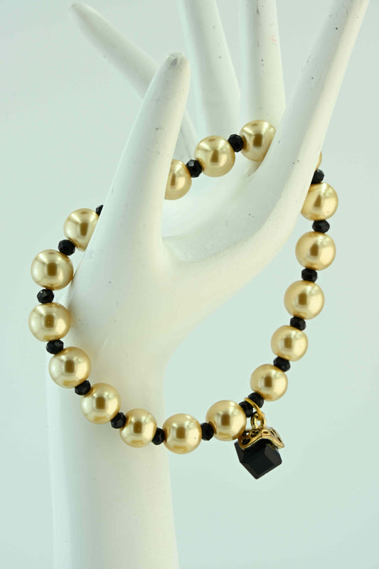 Bransoletka złota z czarnymi akcentami i kryształkiem – elegancka na gumce